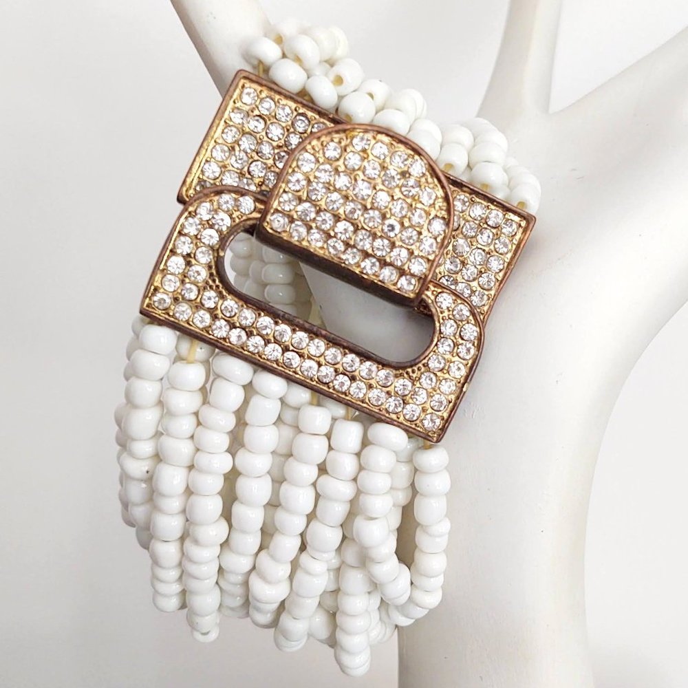 Multi strand white stretch bead with gold metal buckle and crystal accents